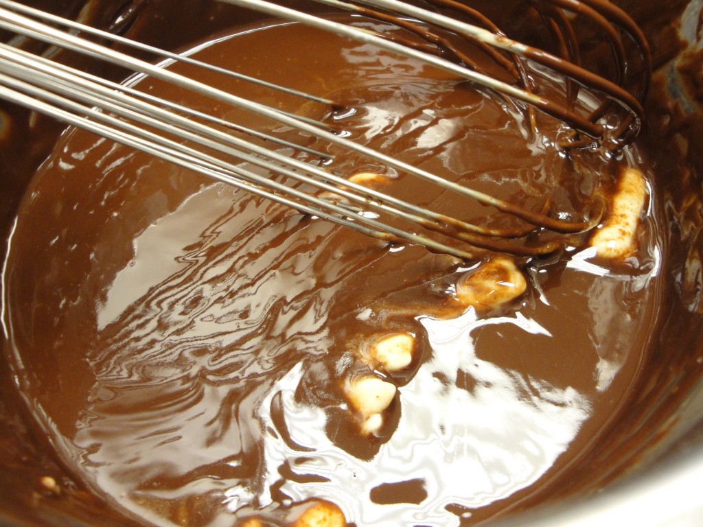 adding butter to chocolate mousse mixture